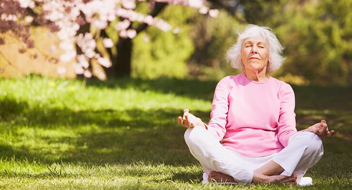 elderly woman meditating with hip arthrosis